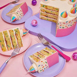 Birthday Cake by Crumbs & Doilies with confetti sponge, vanilla buttercream, rainbow sprinkles, and unicorn meringue.